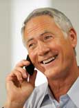 Image of a smiling man on a telephone